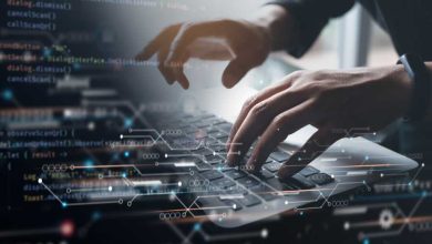 Digital technology, software development concept. Coding programmer working on laptop with circuit board and javascript on virtual screen