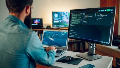 Back view of a senior developer typing code and programming a new generation of AI bots and AI generators at the home office. Artificial intelligence development and programming AI bots.