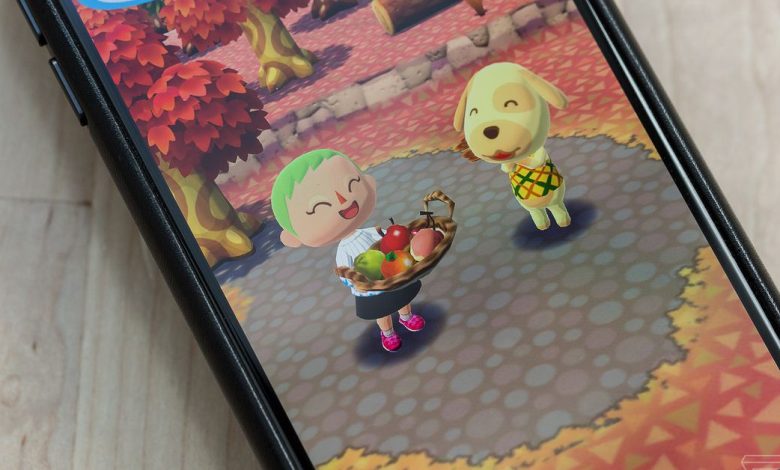 A phone on a table playing Animal Crossing: Pocket Camp.