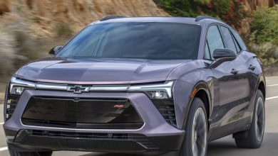 Front 7/8 view of the 2024 Chevrolet Blazer EV RS in Galaxy Gray Metallic driving down the road.