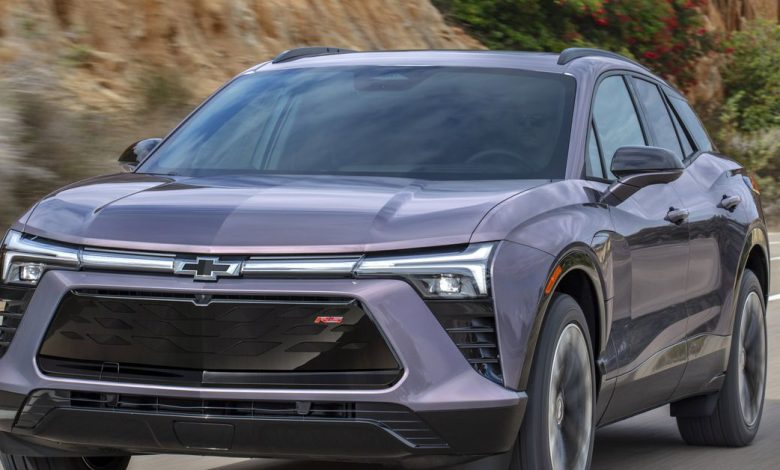 Front 7/8 view of the 2024 Chevrolet Blazer EV RS in Galaxy Gray Metallic driving down the road.