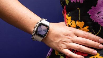 Woman in floral dress with hand on hip modeling Apple watch SE (2022)