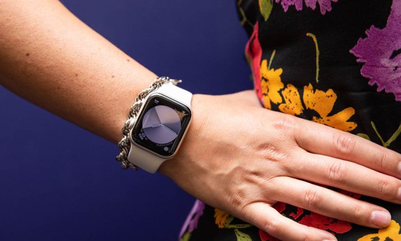 Woman in floral dress with hand on hip modeling Apple watch SE (2022)