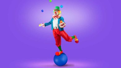 colorfully dressed juggler clown juggling brightly colored blue green red yellow balls against a bright purple background