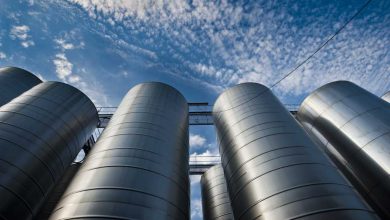 shutterstock 289153913 upward view of silver silos against a blue sky with clouds