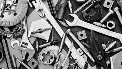 shutterstock 175644863 scattered clutter of nuts bolts wrenches tools in black and white