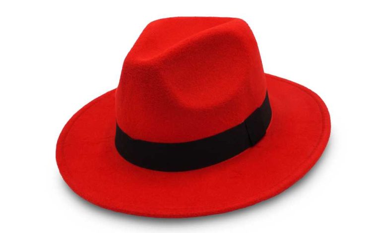 shutterstock 1395239159 red fedora hat with black band on white background red hat