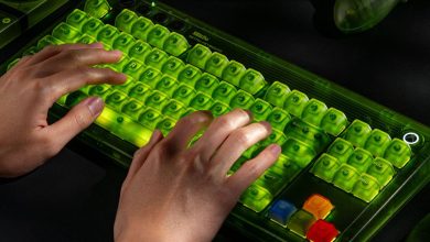 A pair of hands typing on the 8BitDo Retro 87 Mechanical Keyboard - Xbox Edition while it’s glowing green.