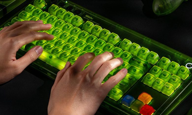 A pair of hands typing on the 8BitDo Retro 87 Mechanical Keyboard - Xbox Edition while it’s glowing green.