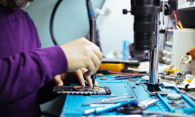 Technician repairing a smartphone.