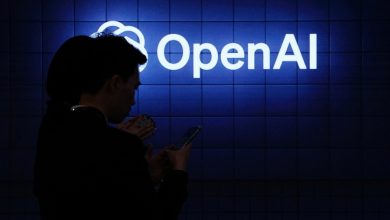 Visitor look at their phone next to an Open AI's logo during the Mobile World Congress (MWC), the telecom industry's biggest annual gathering, in Barcelona on February 26, 2024. The world's biggest mobile phone fair throws open its doors in Barcelona with the sector looking to artificial intelligence to try and reverse declining sales. (Photo by PAU BARRENA/AFP via Getty Images)