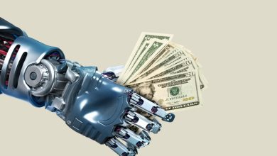 Image of a robot hand holding a fistful of cash to represent funding for robotics startups.