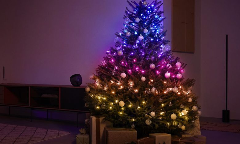 A tree decorated with Philips Hue’s Festavia smart string lights in a dark room.