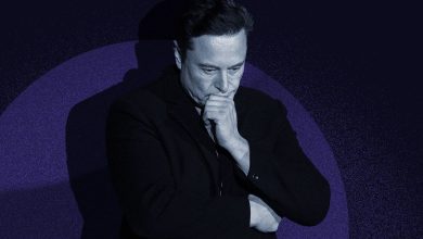 Elon Musk pontificates against a spotlight and blue background