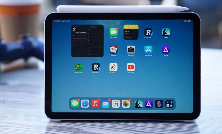 A 9th gen iPad on a wood table viewed from the top down