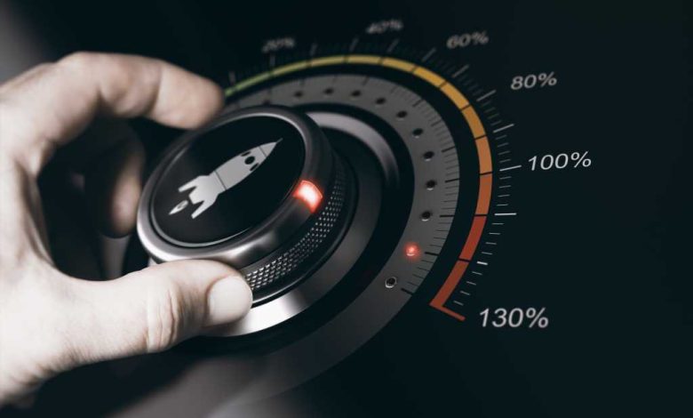 Hand turning a button with a rocket icon to the maximum acceleration. Concept of career acceleration. Composite between an image and a 3D background.