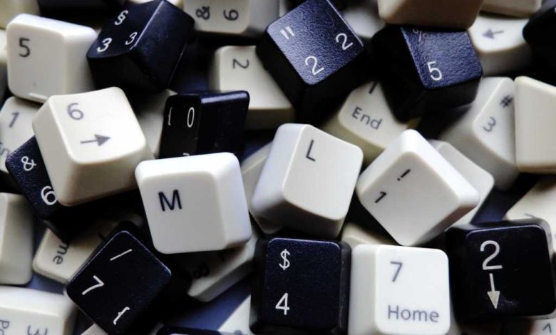 Black and white computer keyboard keys, mostly numeric with M and L (machine learning) keys in foreground. Concept of unstructured big data for data science and deep learning.