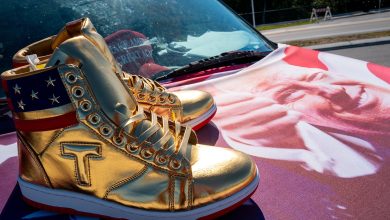 Image of Trump branded shoes on the hood of a car.