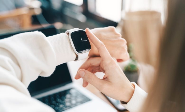 Modern woman using smart watch for daily tasks, interacting with the touchscreen user interface. Tracking health habits, messaging, checking on time with simple application software.